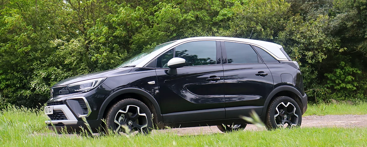 Vauxhall Crossland driving next to trees