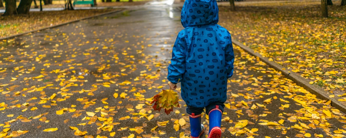 Toddler in wellies and rain coat