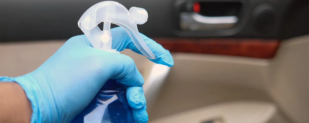 gloved hand with spray bottle