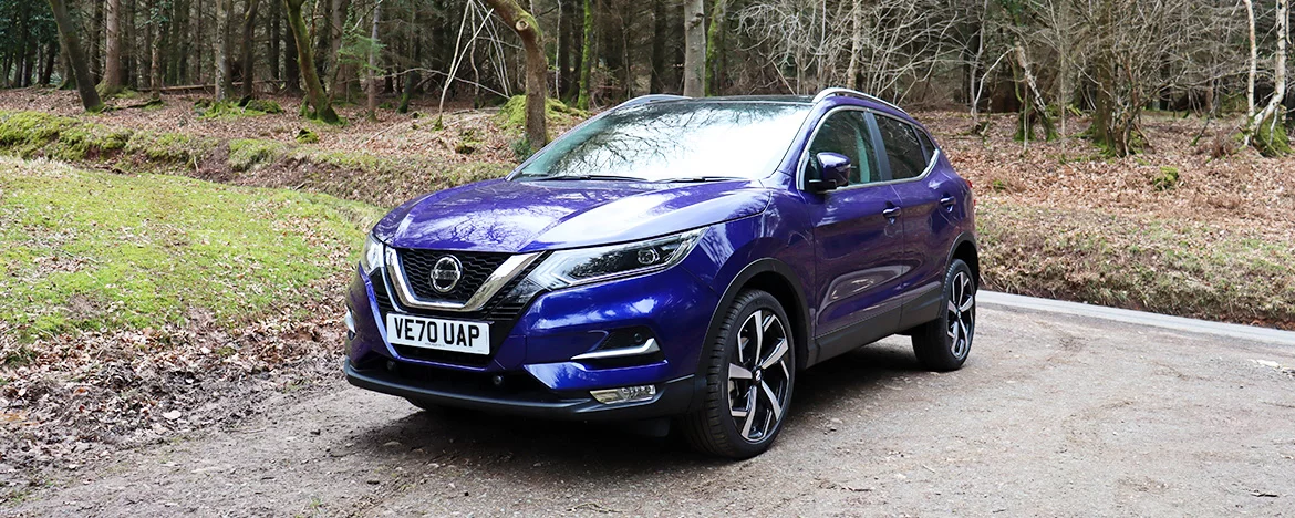 Nissan Qashqai parked in the woods