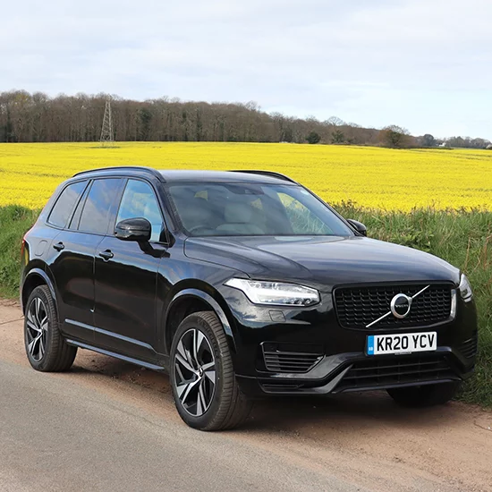 Volvo XC90 parked in front of fields